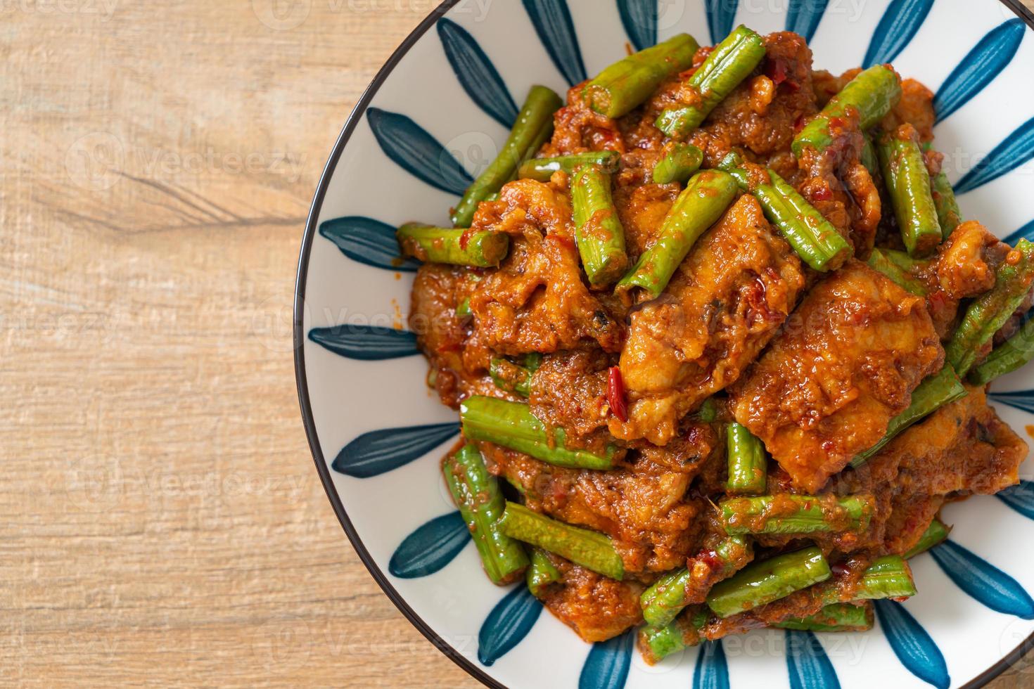 Stir fried pork with red curry paste photo