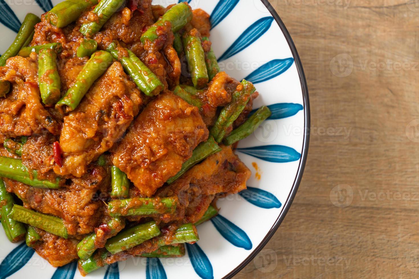 Stir fried pork with red curry paste photo