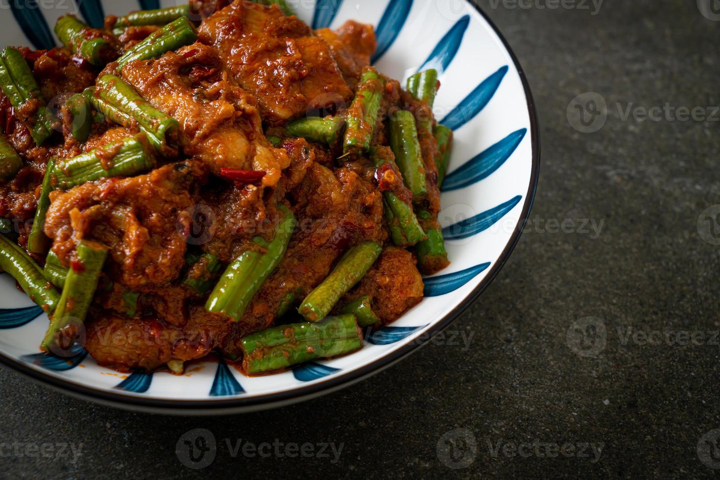 Stir fried pork with red curry paste photo