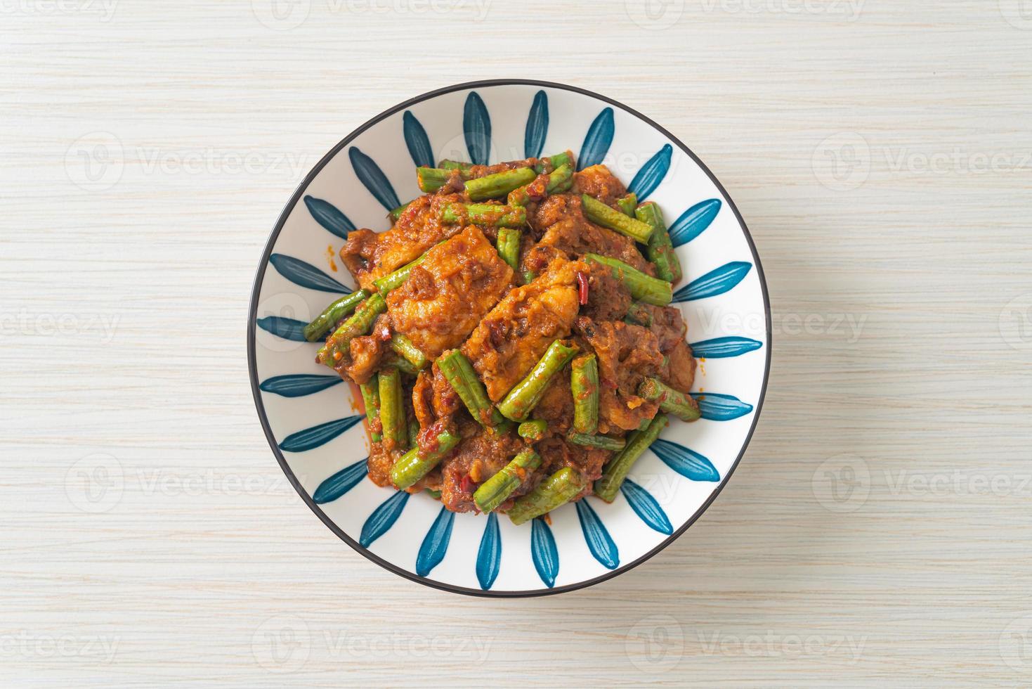 Stir fried pork with red curry paste photo