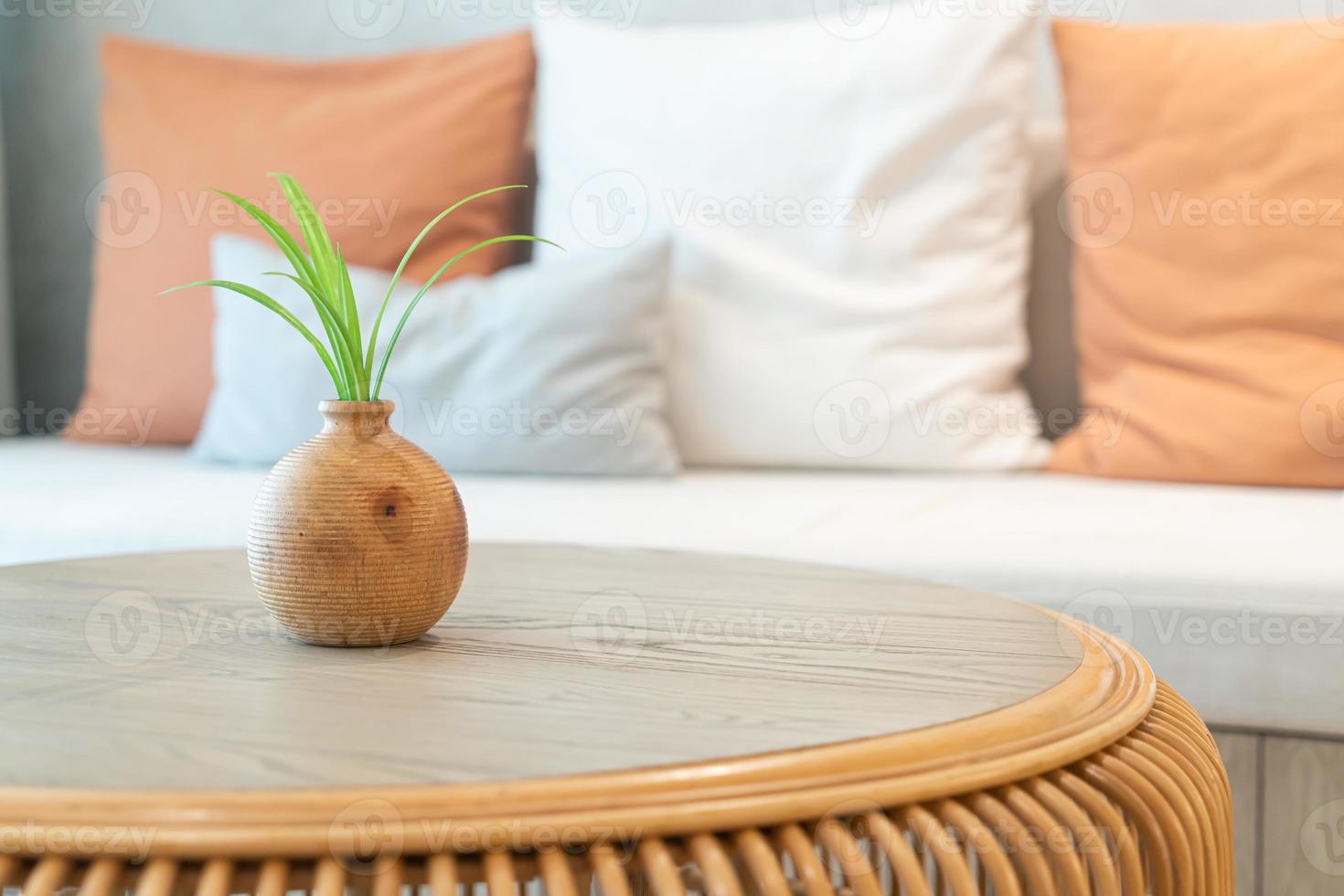 ceramic or porcelain vase with plant decoration on table in living room photo