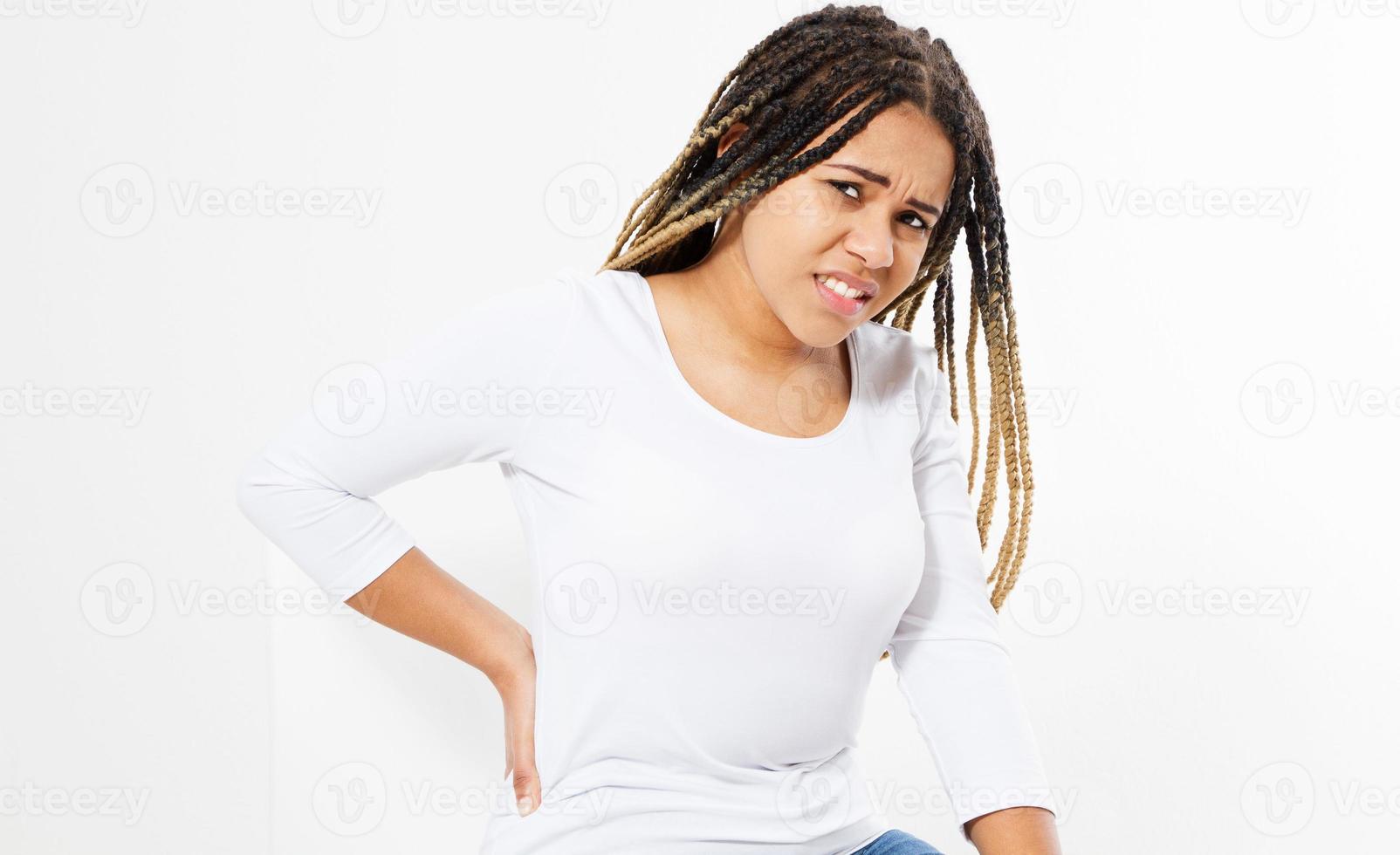 beautiful young woman suffering from backache on chair - front view photo