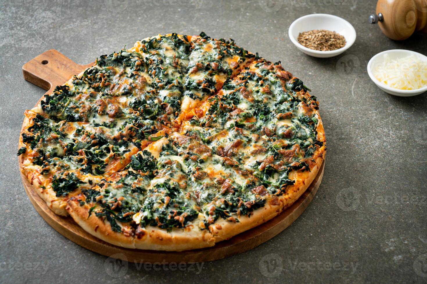 spinach and cheese pizza on wood tray photo