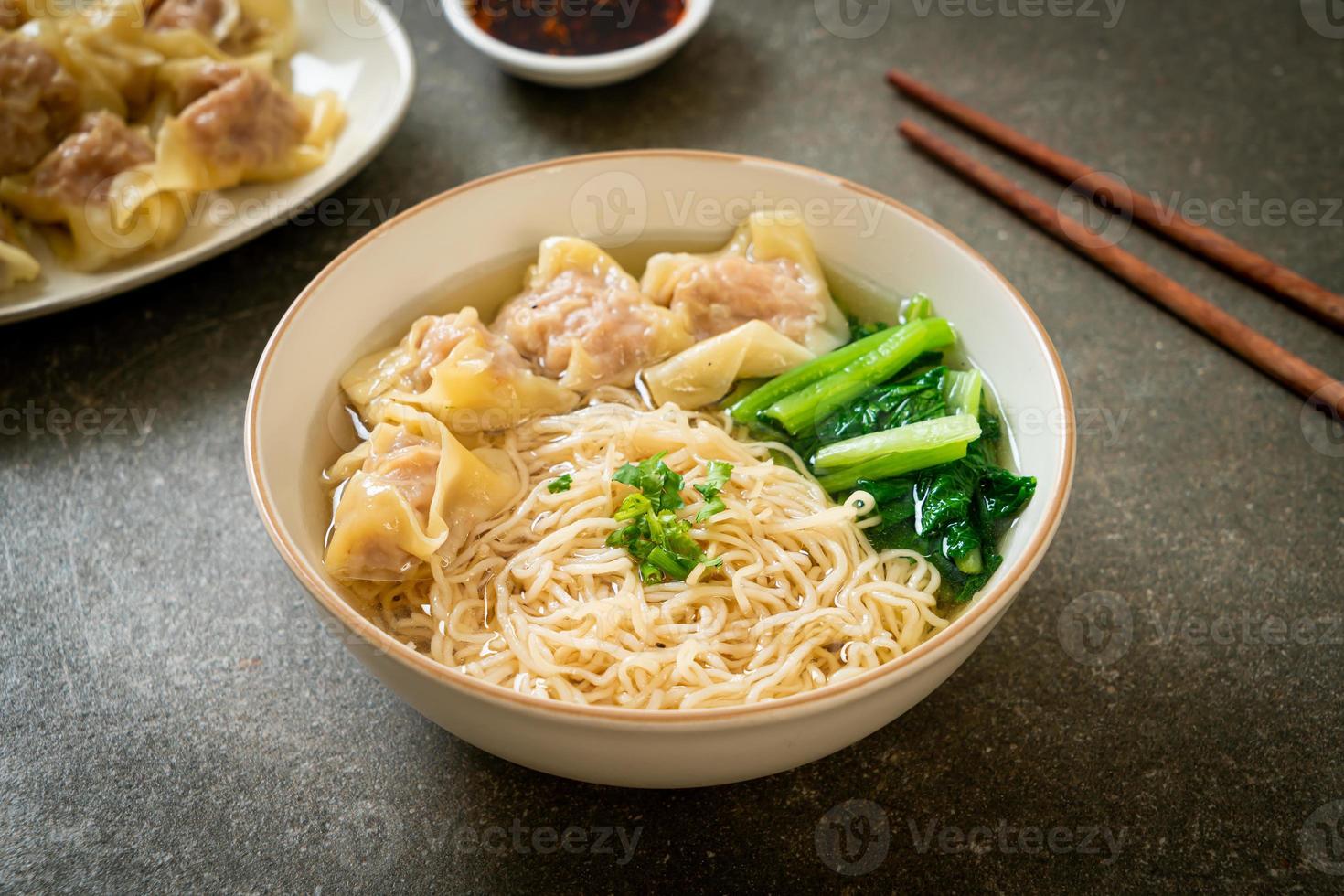 egg noodles with pork wonton soup or pork dumplings soup and vegetable photo