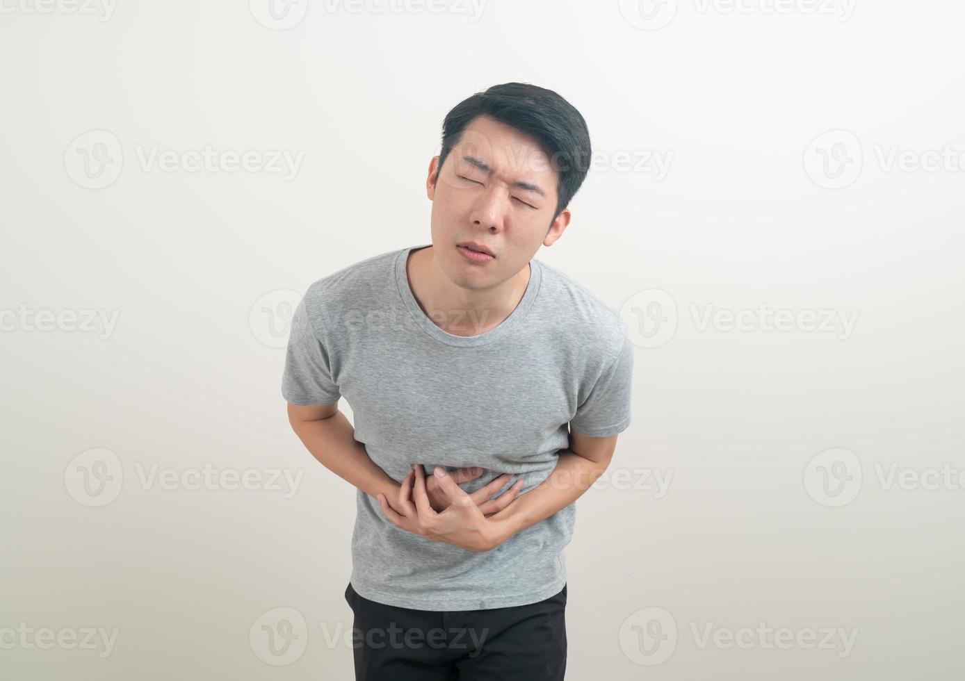 young Asian man having stomach ache photo