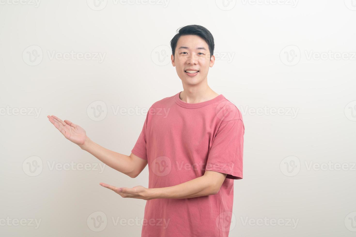 Asian man with hand pointing or presenting on white background photo