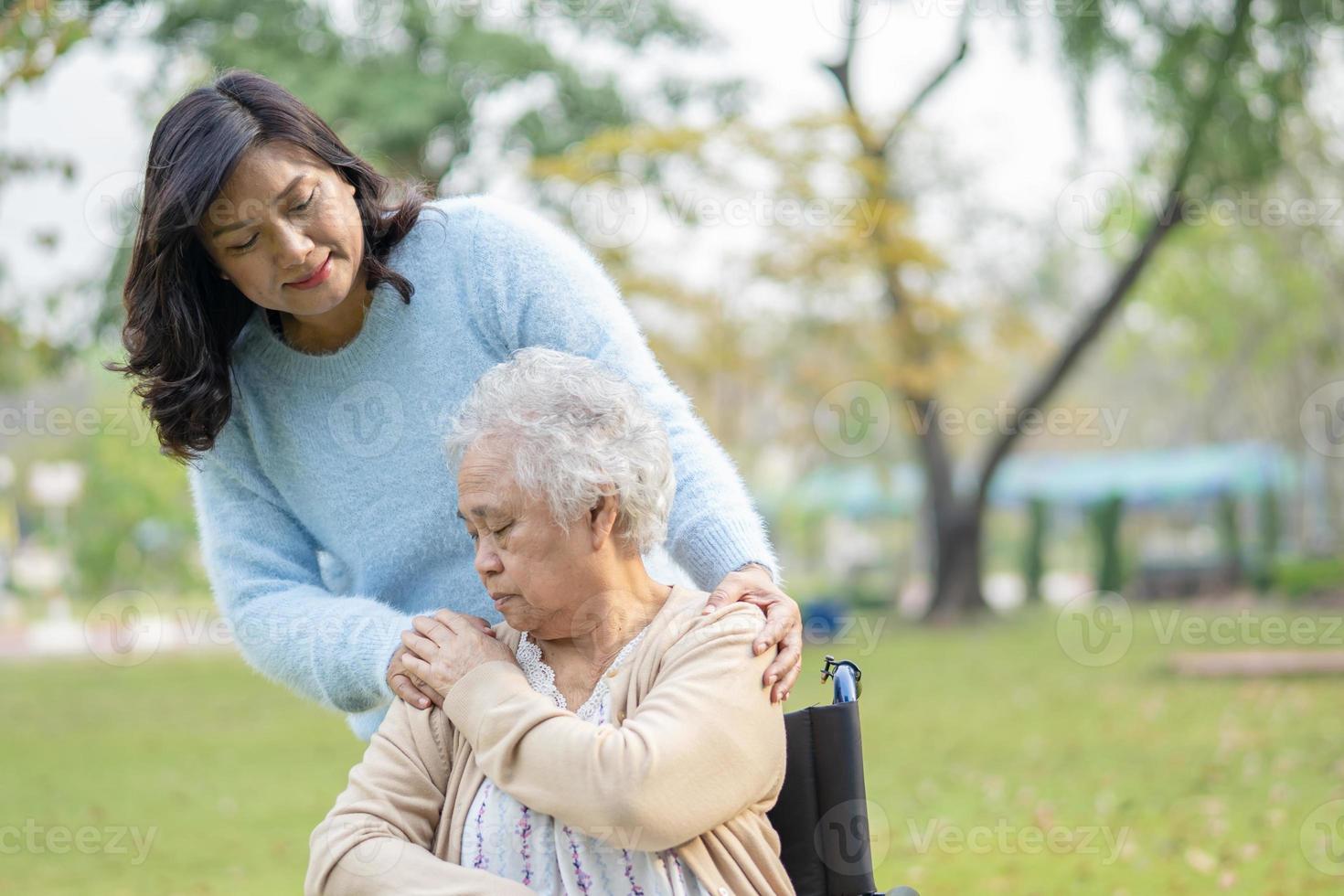 Help and care Asian senior or elderly old lady woman use walker with strong health while walking at park in happy fresh holiday. photo