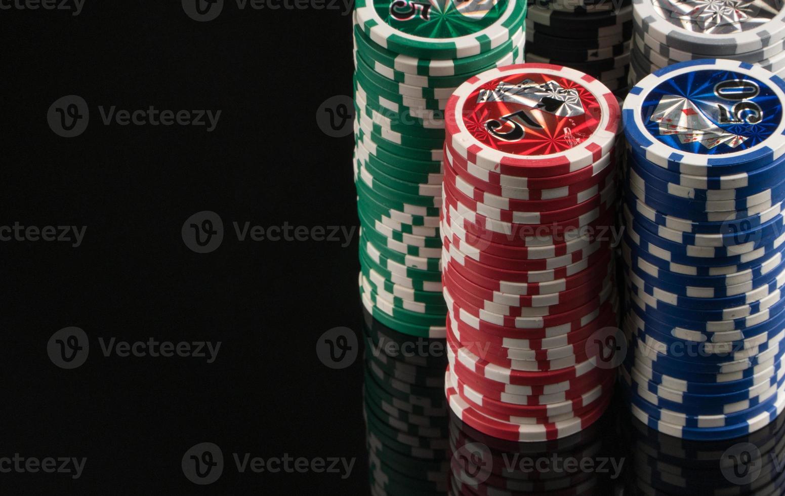 Casino chips on a black background with reflection. The concept of gambling and entertainment. Casino and poker photo