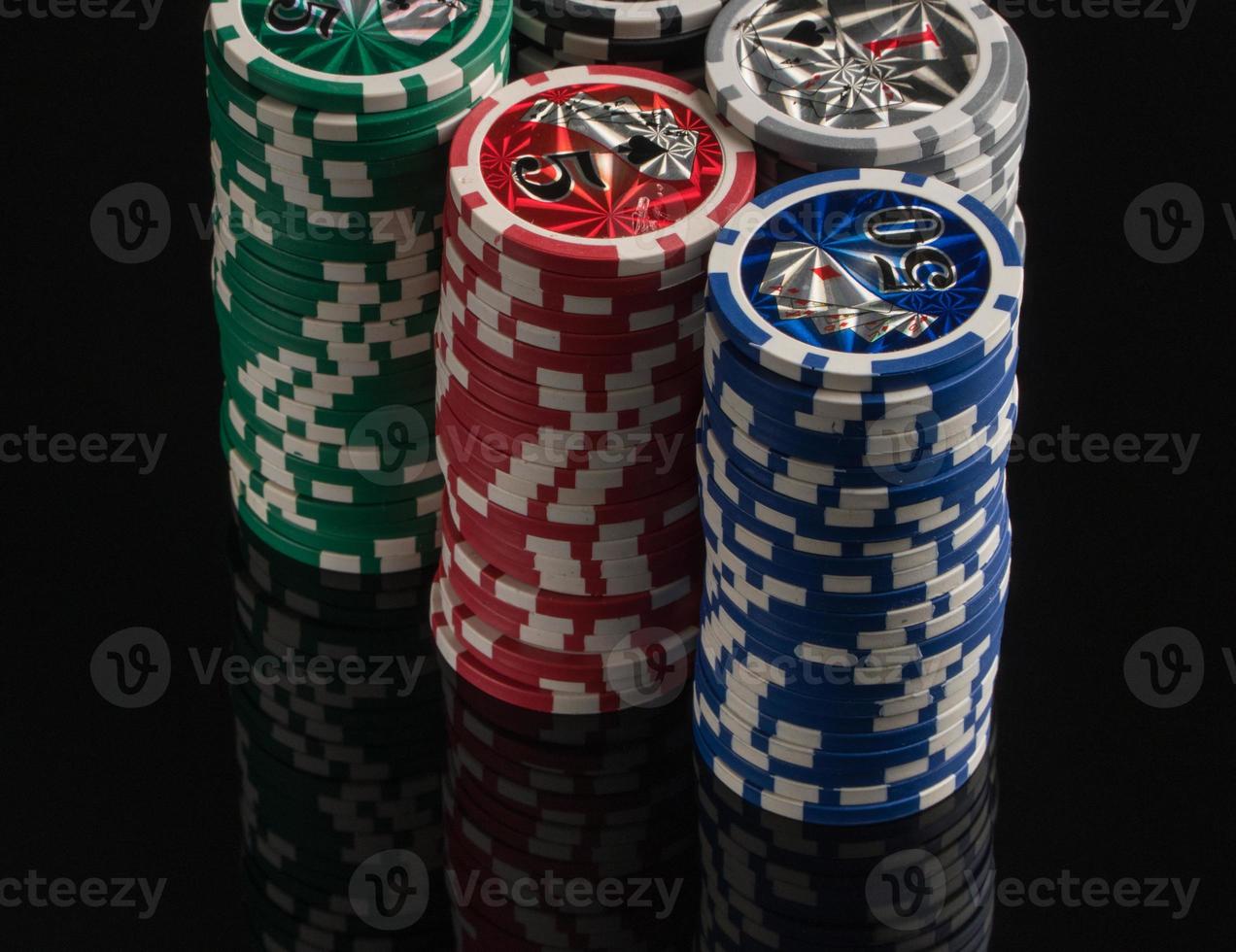 Casino chips on a black background with reflection. The concept of gambling and entertainment. Casino and poker photo