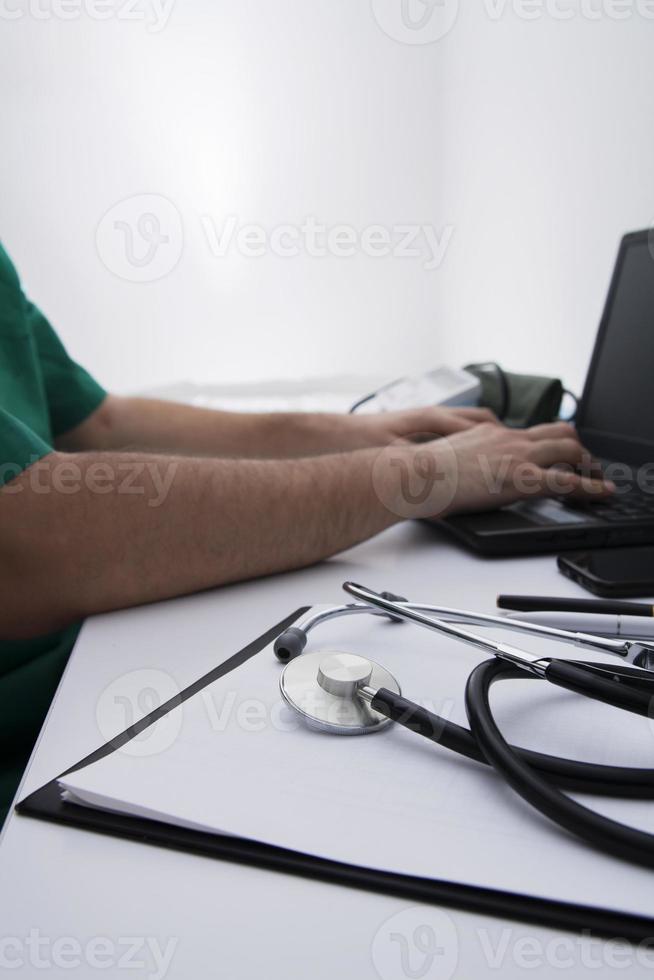 Doctors workplace, in focus stethoscope on clip board photo