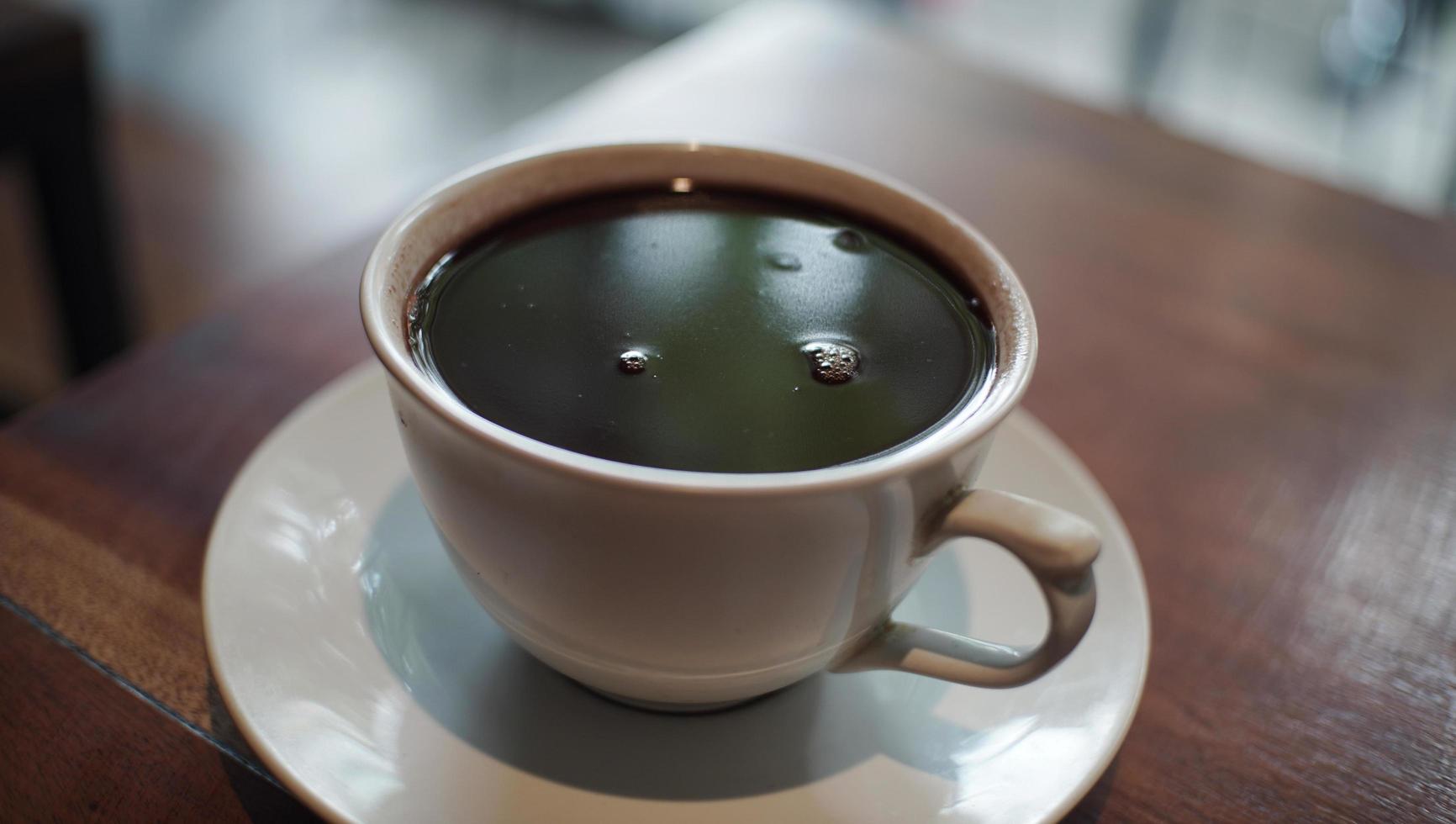 A close up view of a cup of black coffee photo