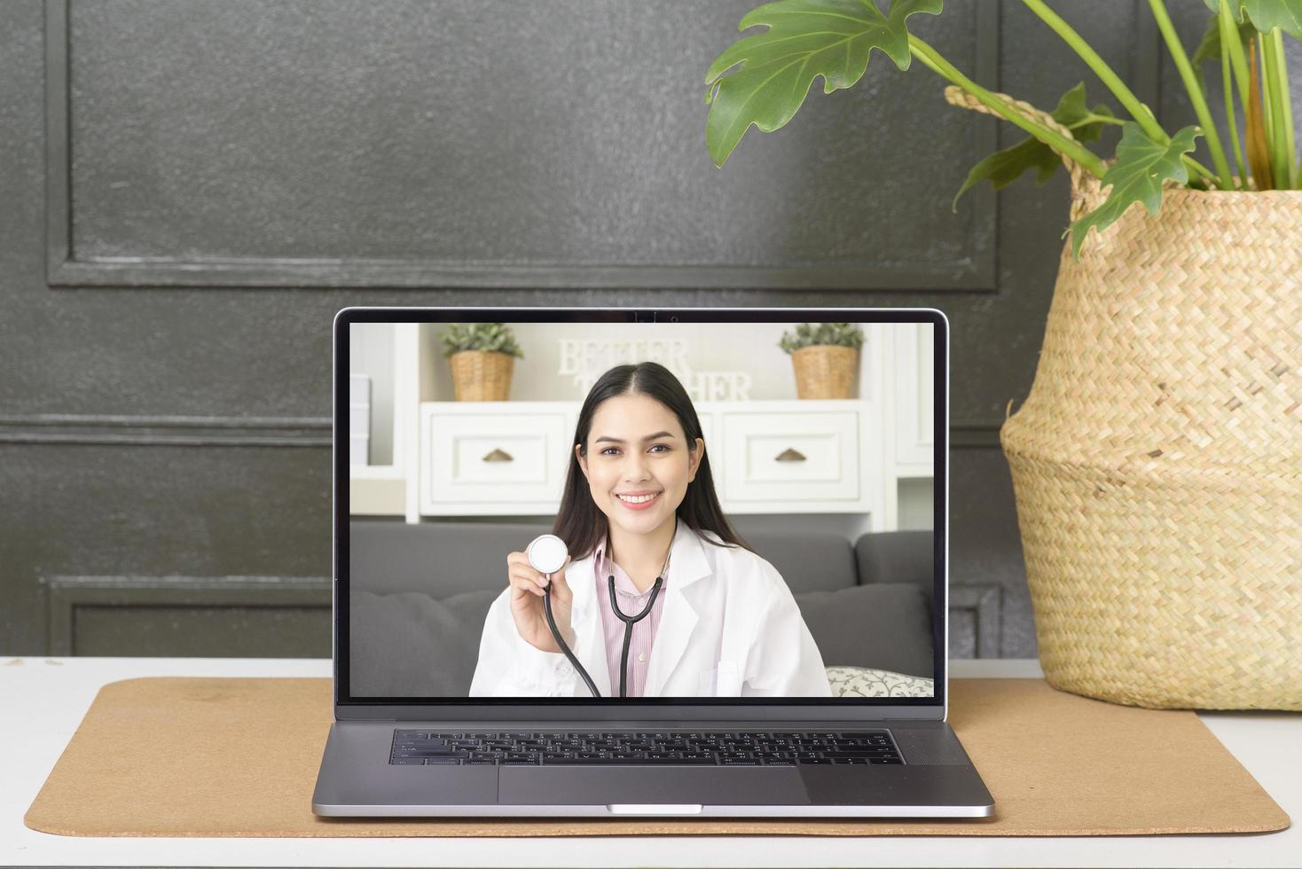 Female doctor making video call on social network with patient consulting about health problems. photo