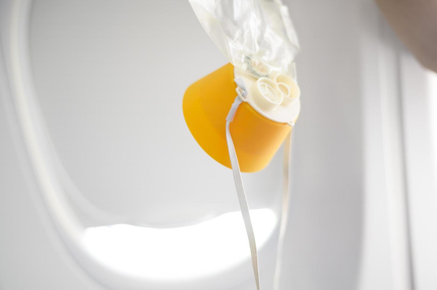 oxygen mask drop from the ceiling compartment on airplane photo