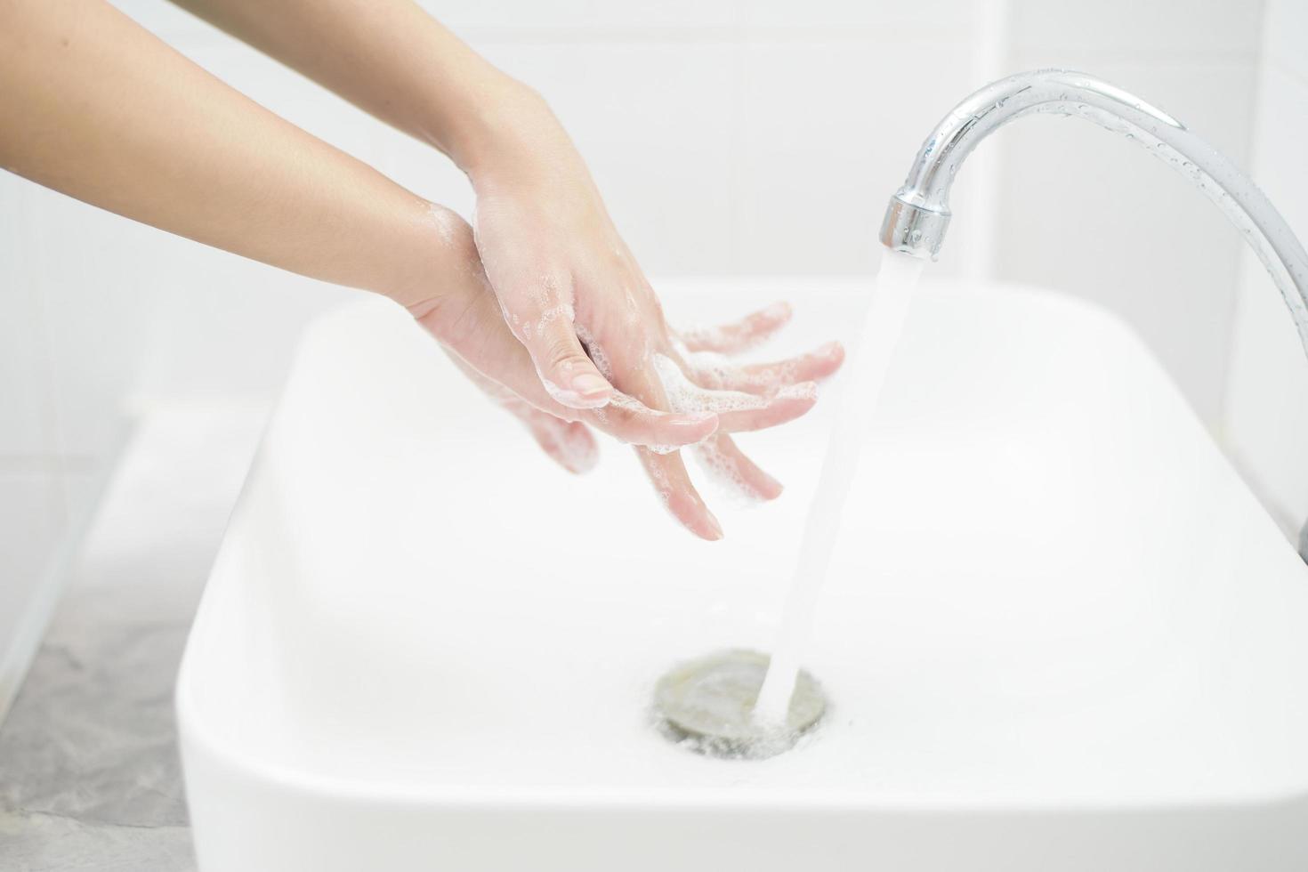 A woman is washing hands photo