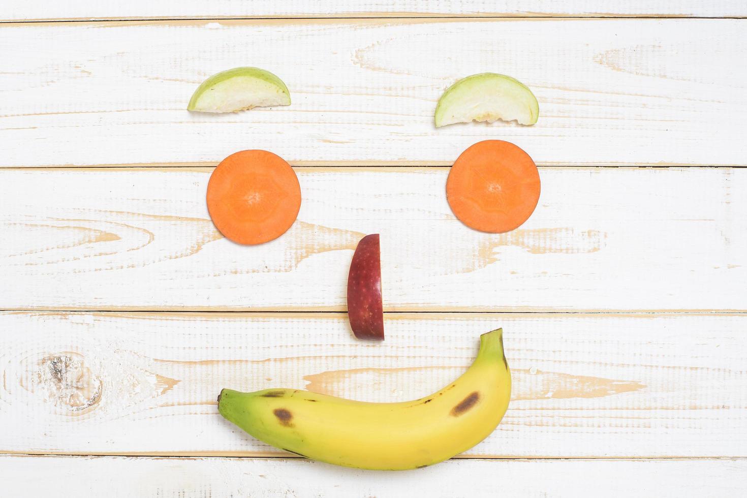 face fruit on wooden white background photo