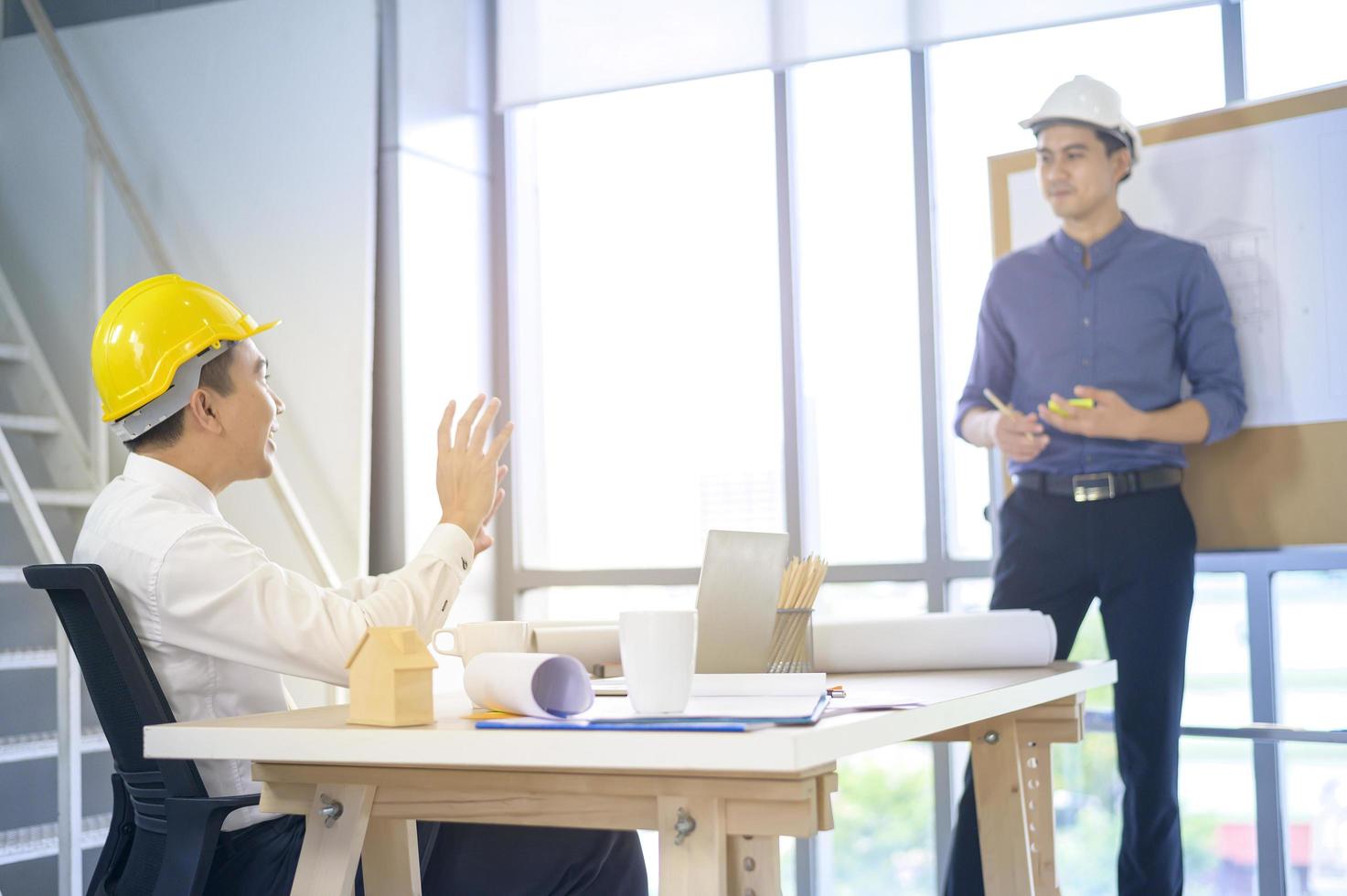 young male and female engineer presenting the ideas and discuss plans to colleague in a meeting room, Group people business concept photo