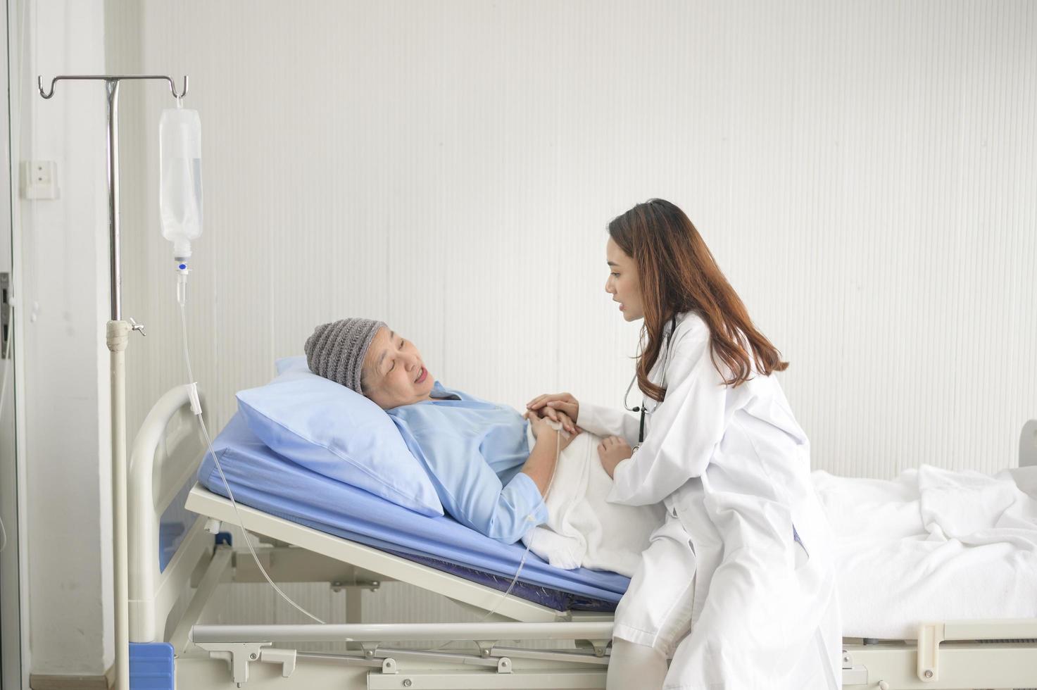 Cancer patient woman wearing head scarf after chemotherapy consulting and visiting doctor in hospital. photo