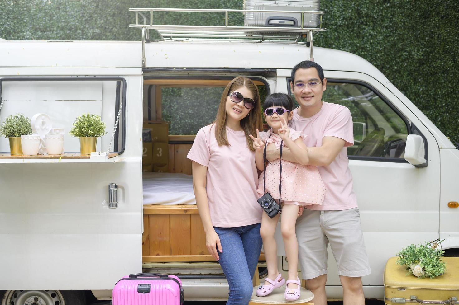a joyful Asian family enjoying road trip and journey is going on holiday, travel and tourism concept photo
