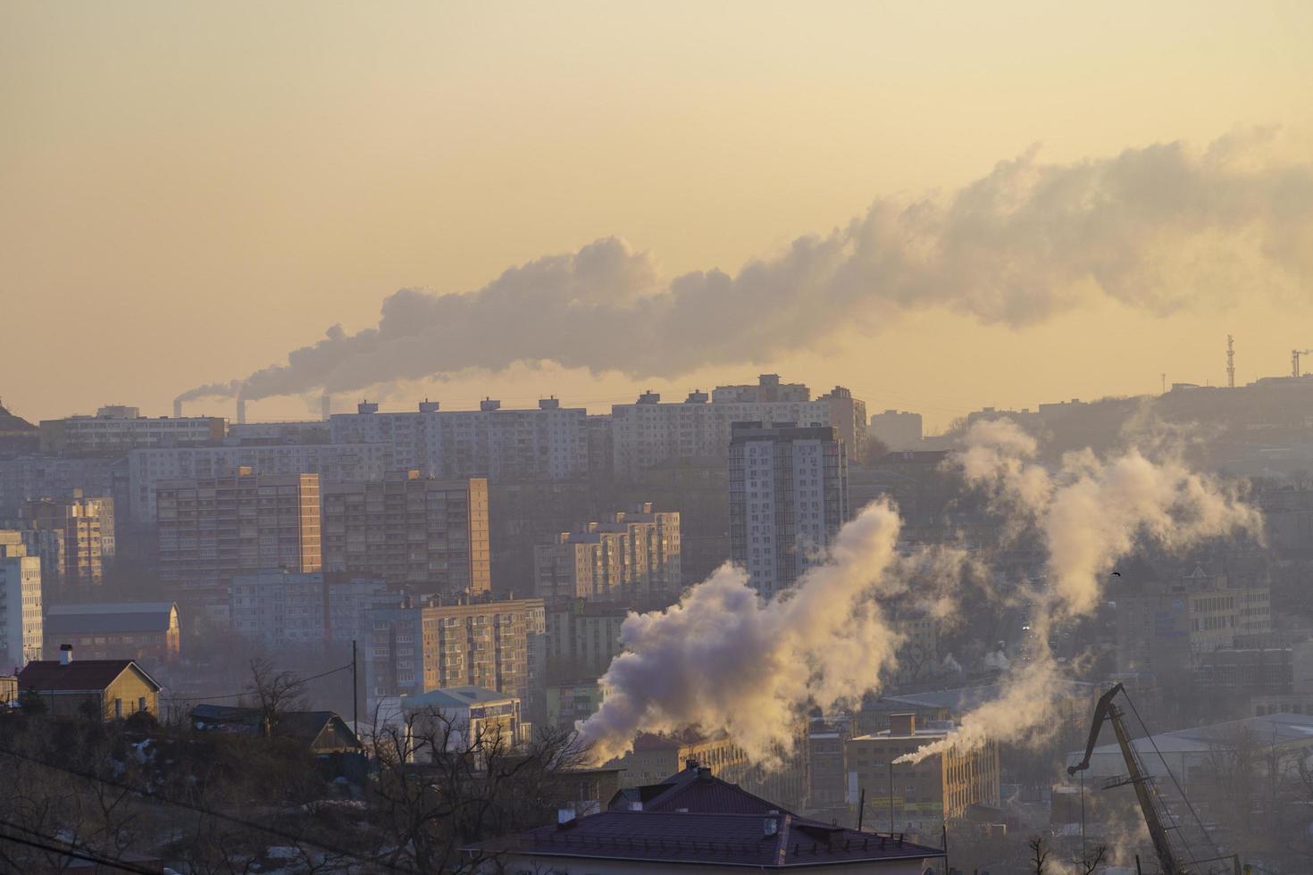 Urban landscape with smoke from heating systems. photo