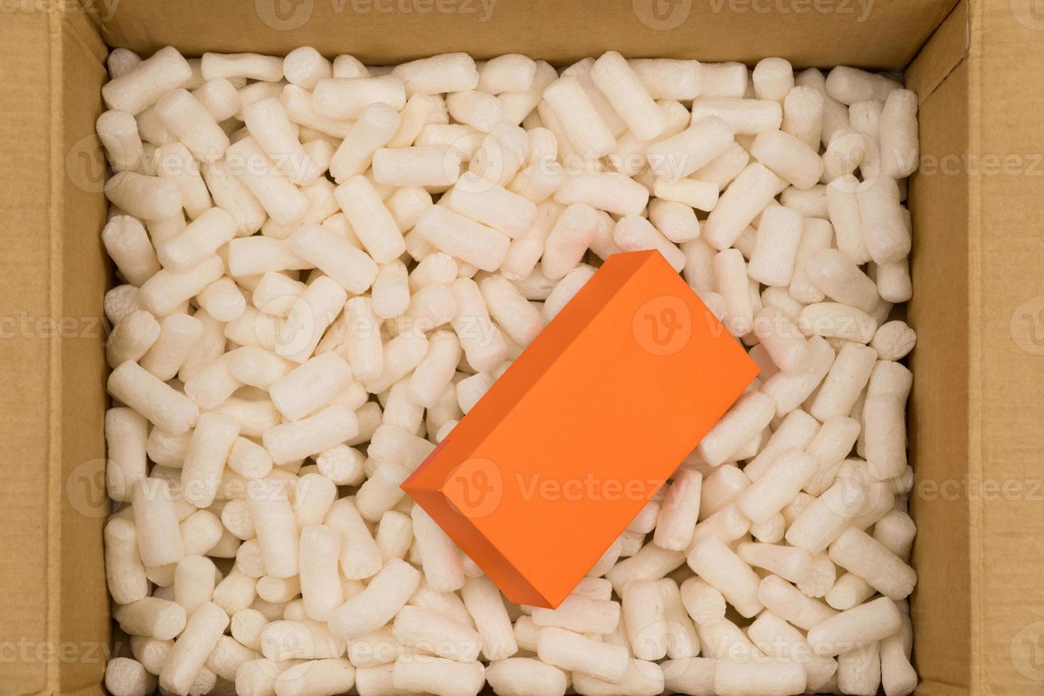 Cardboard box with styrofoam filler for safe packaging. Gift package. Top view photo