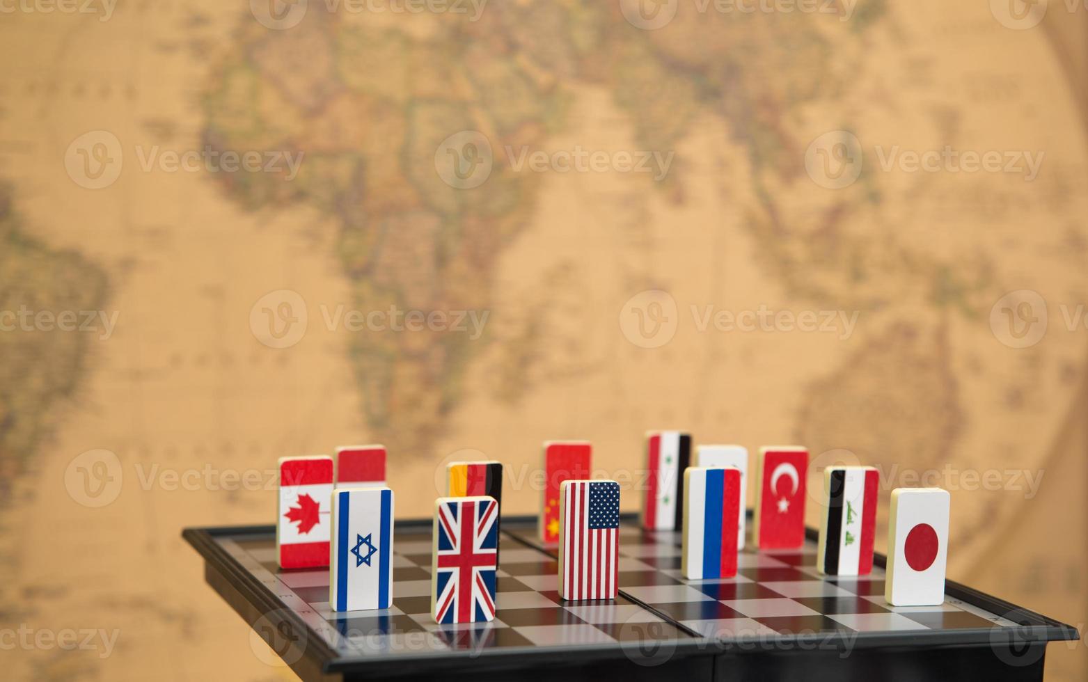 Symbols of countries on the chessboard against against the background the political map of the world. Political games. photo