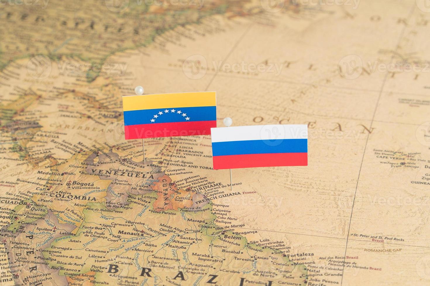 Flags of Russia and Venezuela on the world map. Conceptual photo, politics and world order photo