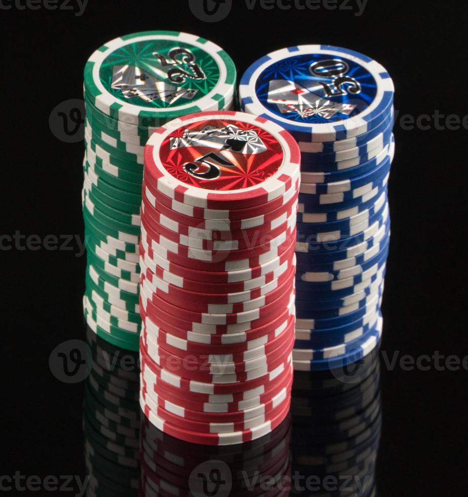 Casino chips on a black background with reflection. The concept of gambling and entertainment. Casino and poker photo
