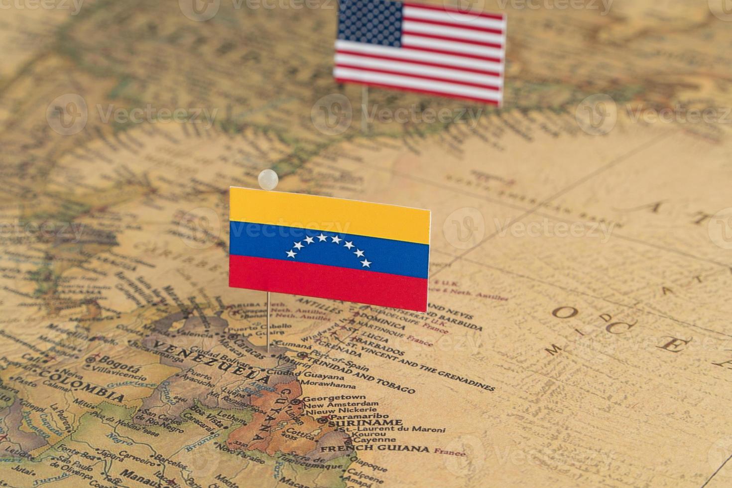 Flags of the USA and Venezuela on the world map. Conceptual photo, politics and world order photo