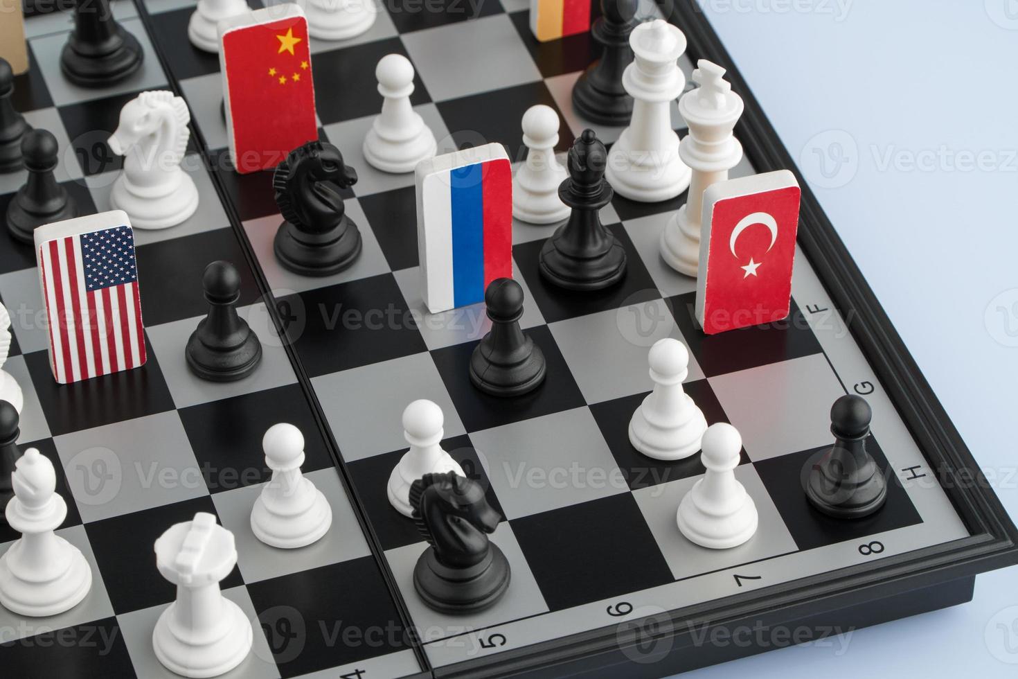 Symbols of the flags of the world on the chessboard. The concept of political game. photo