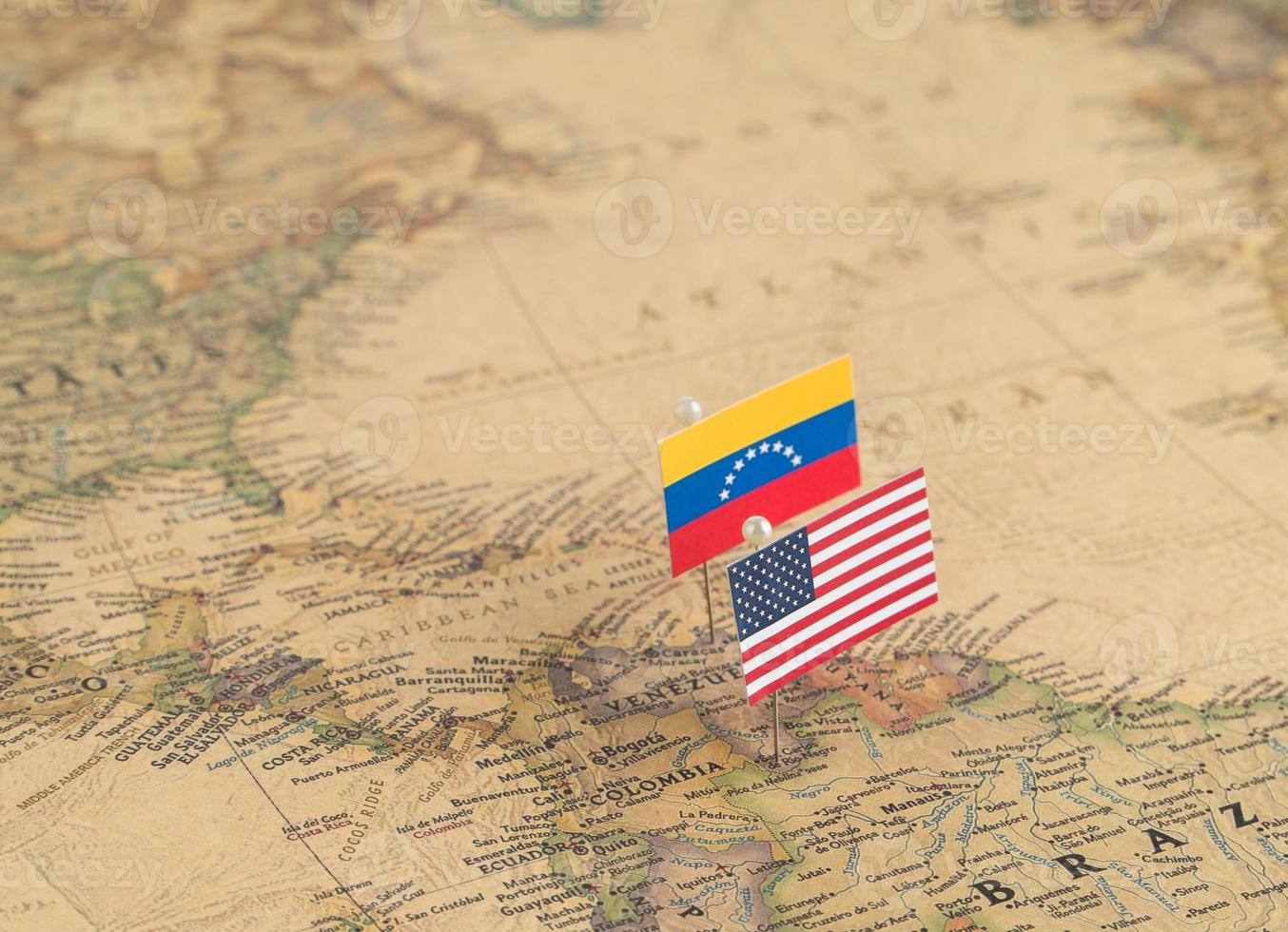 Flags of the USA and Venezuela on the world map. Conceptual photo, politics and world order photo