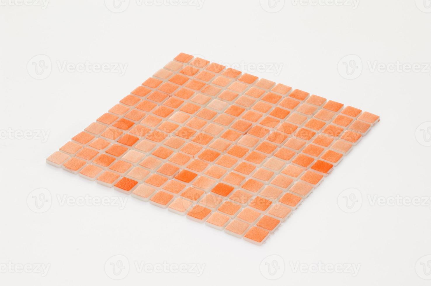 little orange ceramic tile on a white background, majolica. for the catalog photo