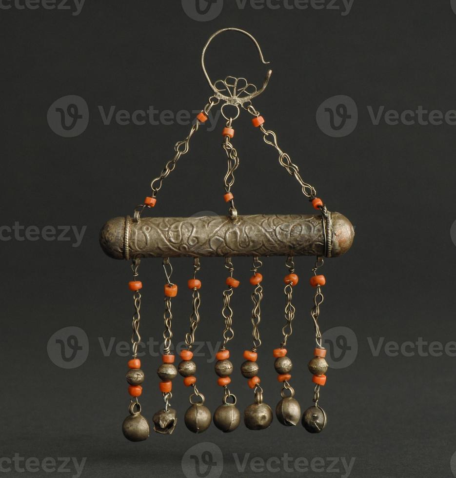 ancient antique pendant with stones on black background. Middle Asian vintage jewelry photo