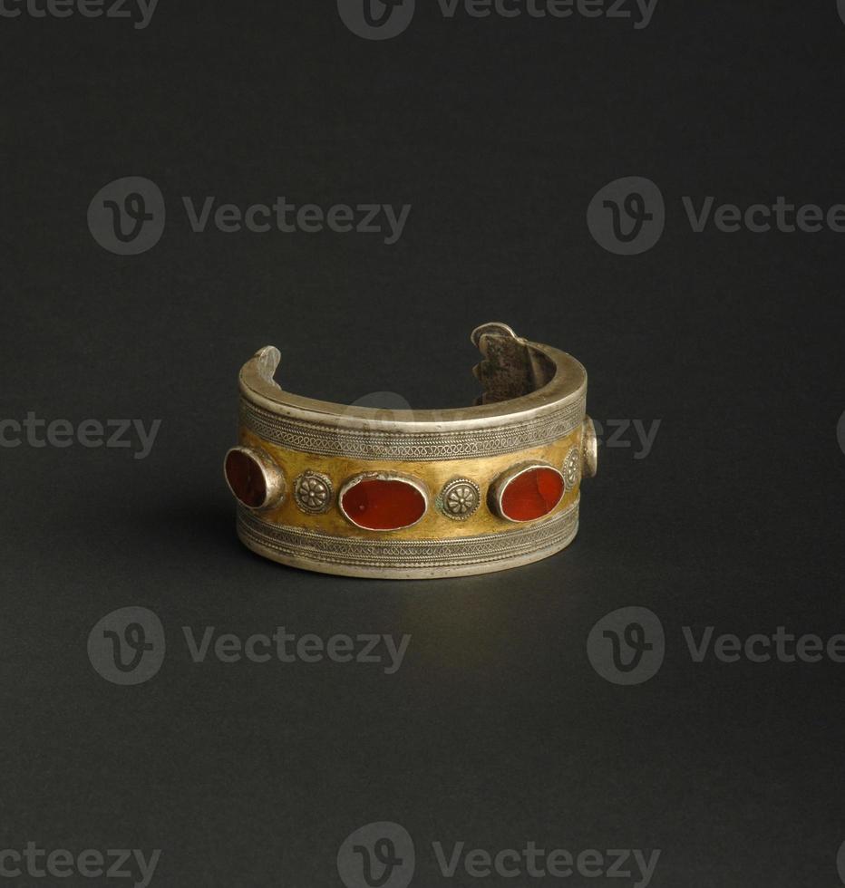 ancient antique bracelet with stones on black background. Middle Asian vintage jewelry photo