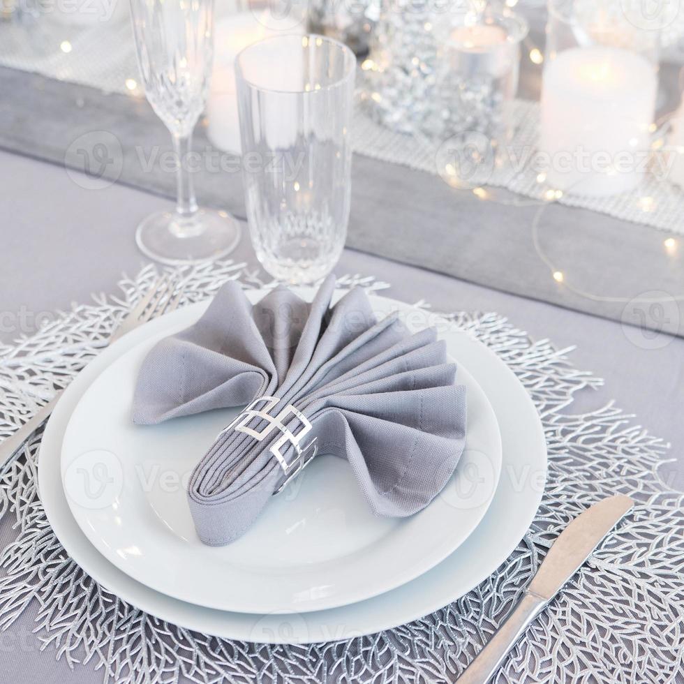 Beautiful table setting with Christmas decorations. Silver colors photo