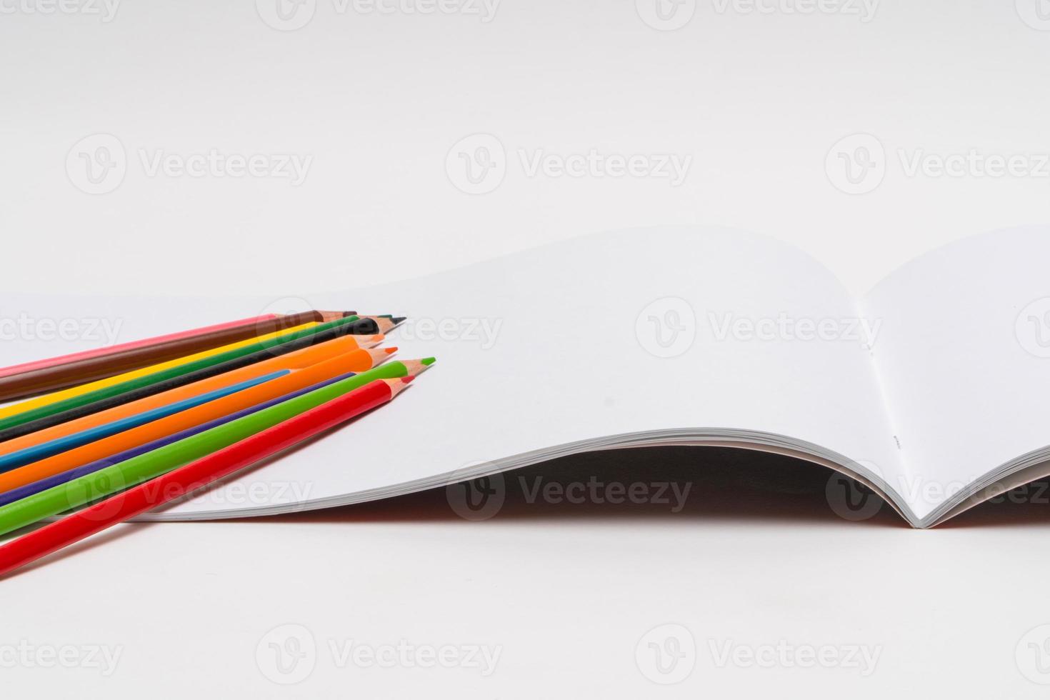 drawing album and color pencils on a white background. back to school photo