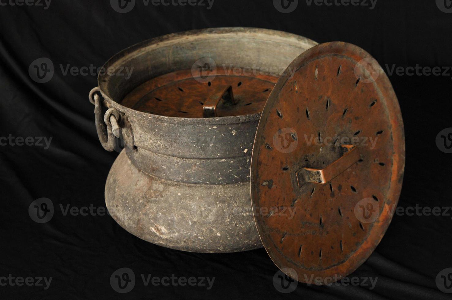 ancient metal bowl on dark background. antique bronze tableware photo