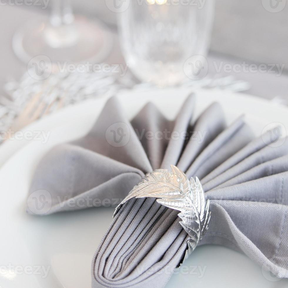 Beautiful table setting with Christmas decorations. Silver colors photo