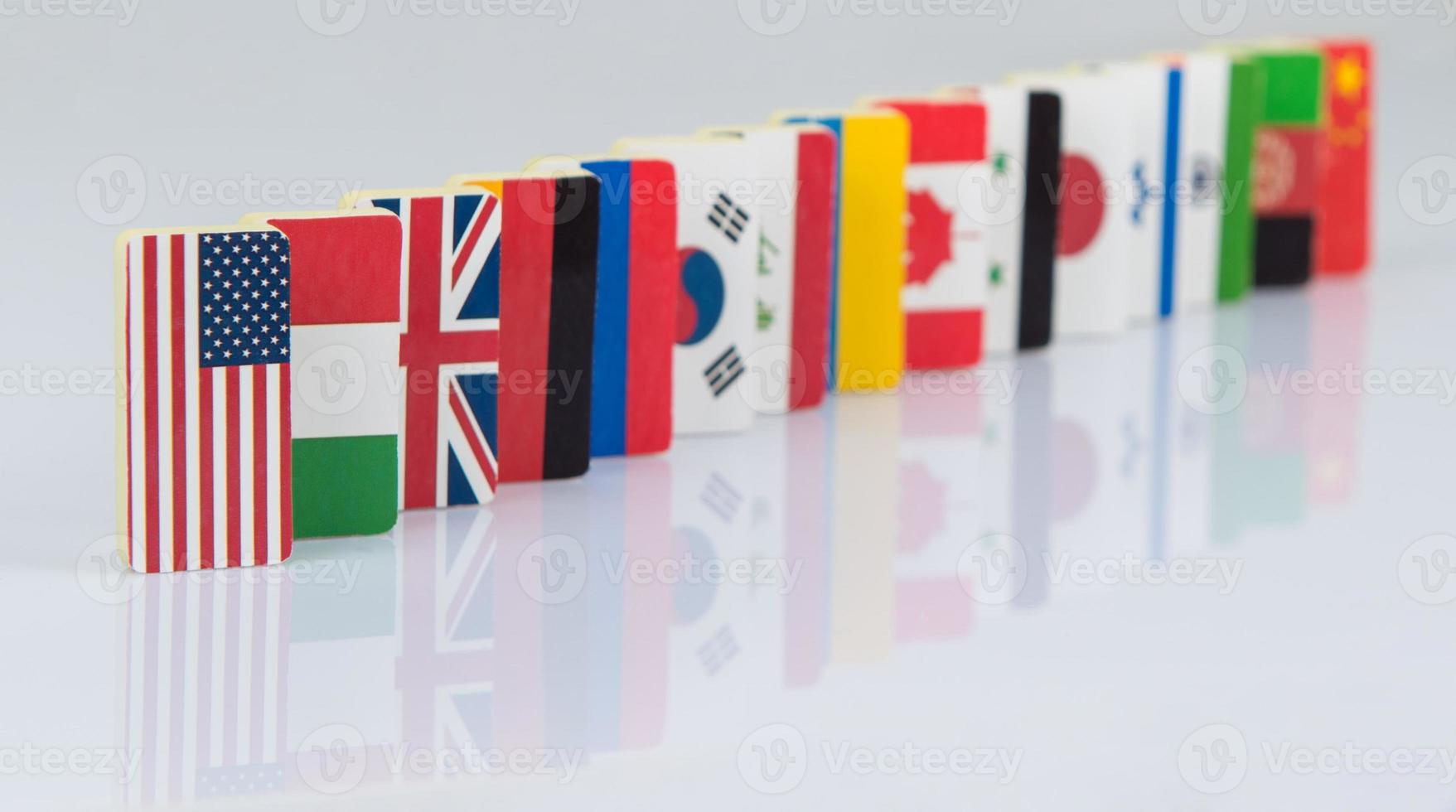 Domino effect with tiles of flags of different countries of the world. conceptual photo, political games photo