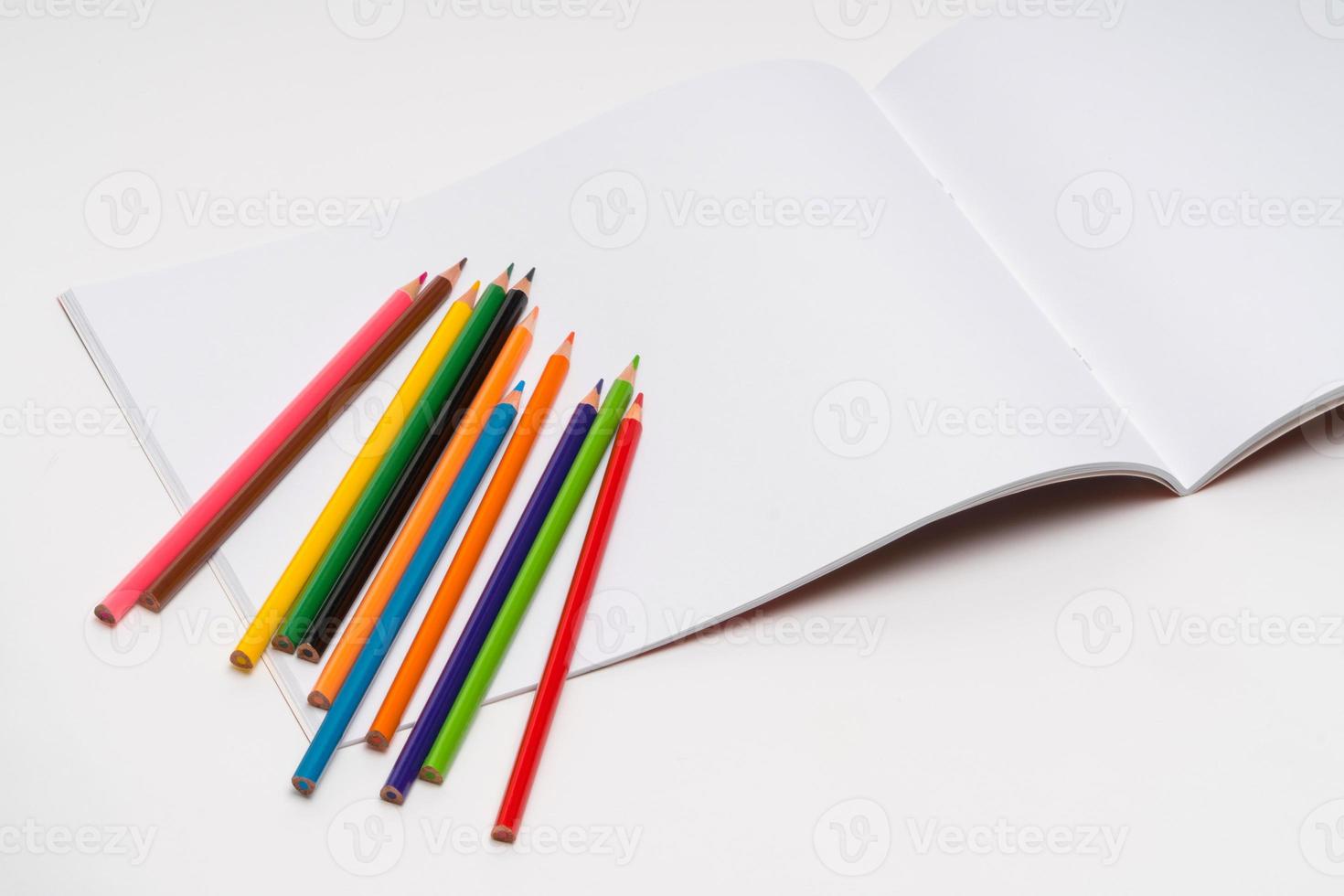 drawing album and color pencils on a white background. back to school photo