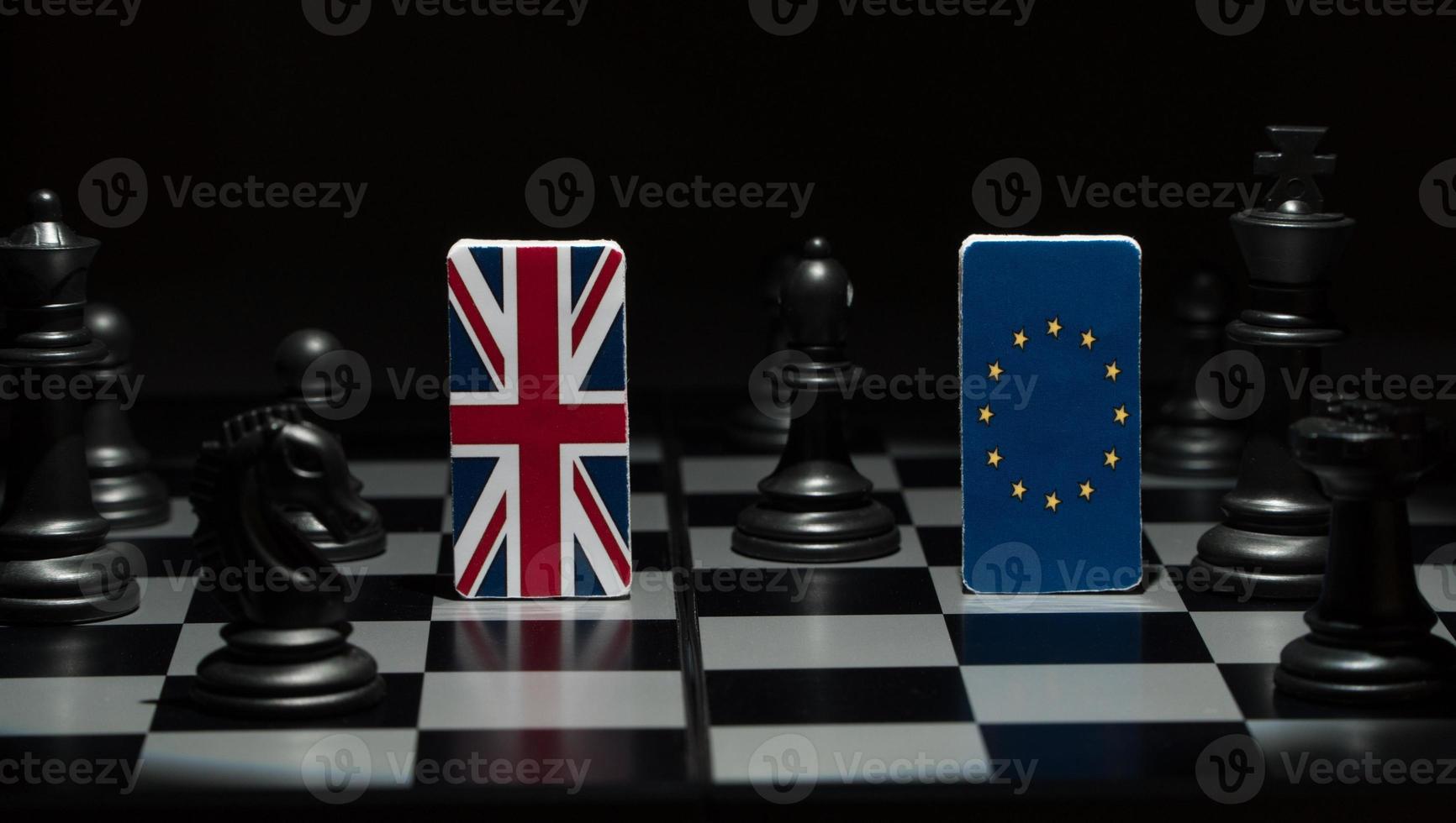 Backlit in the shadows figures and flags of the European Union and Great Britain on the chessboard. The concept of the political game and chess strategy Brexit photo