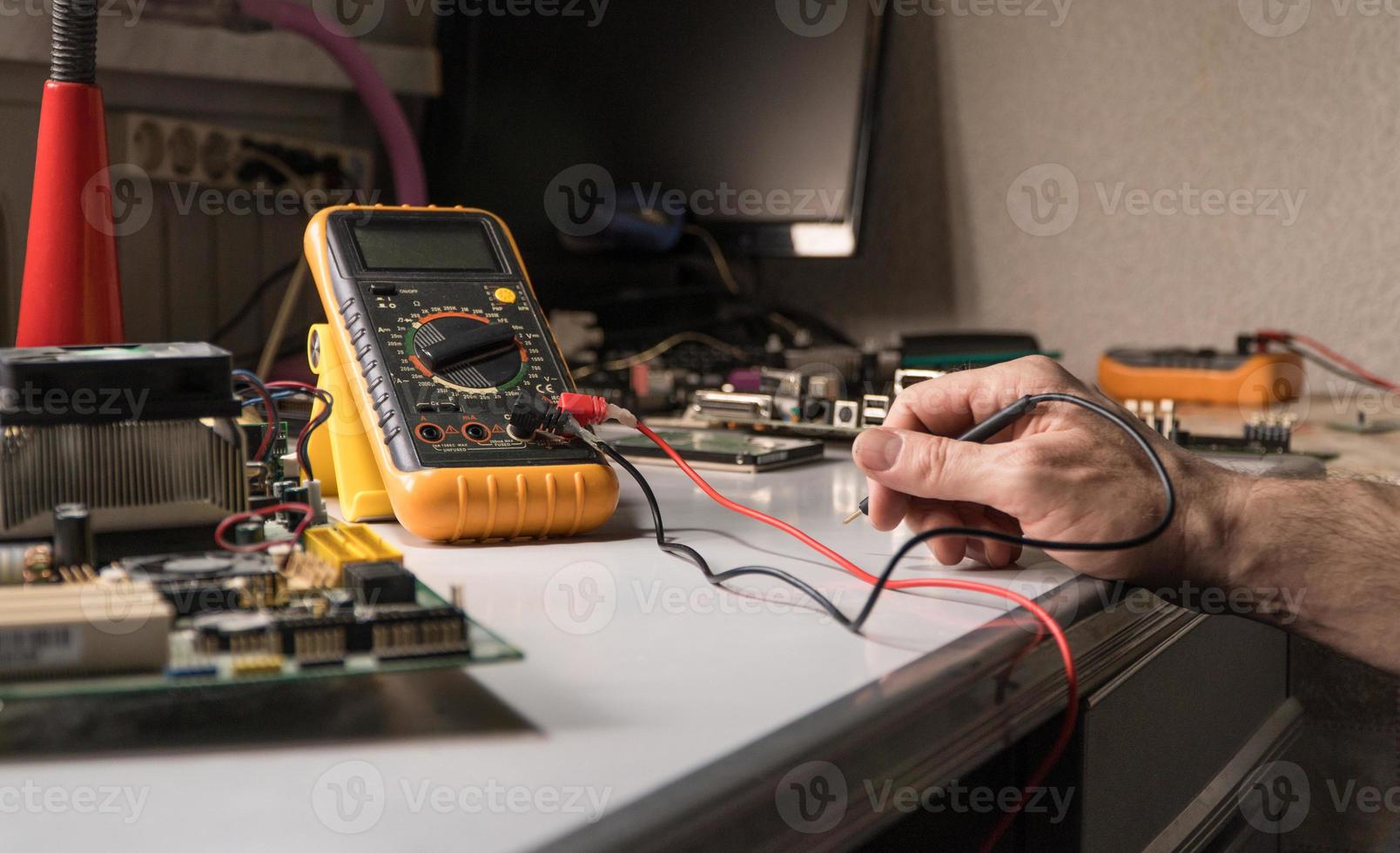 electronics technician is testing a computer chip. PC repair photo