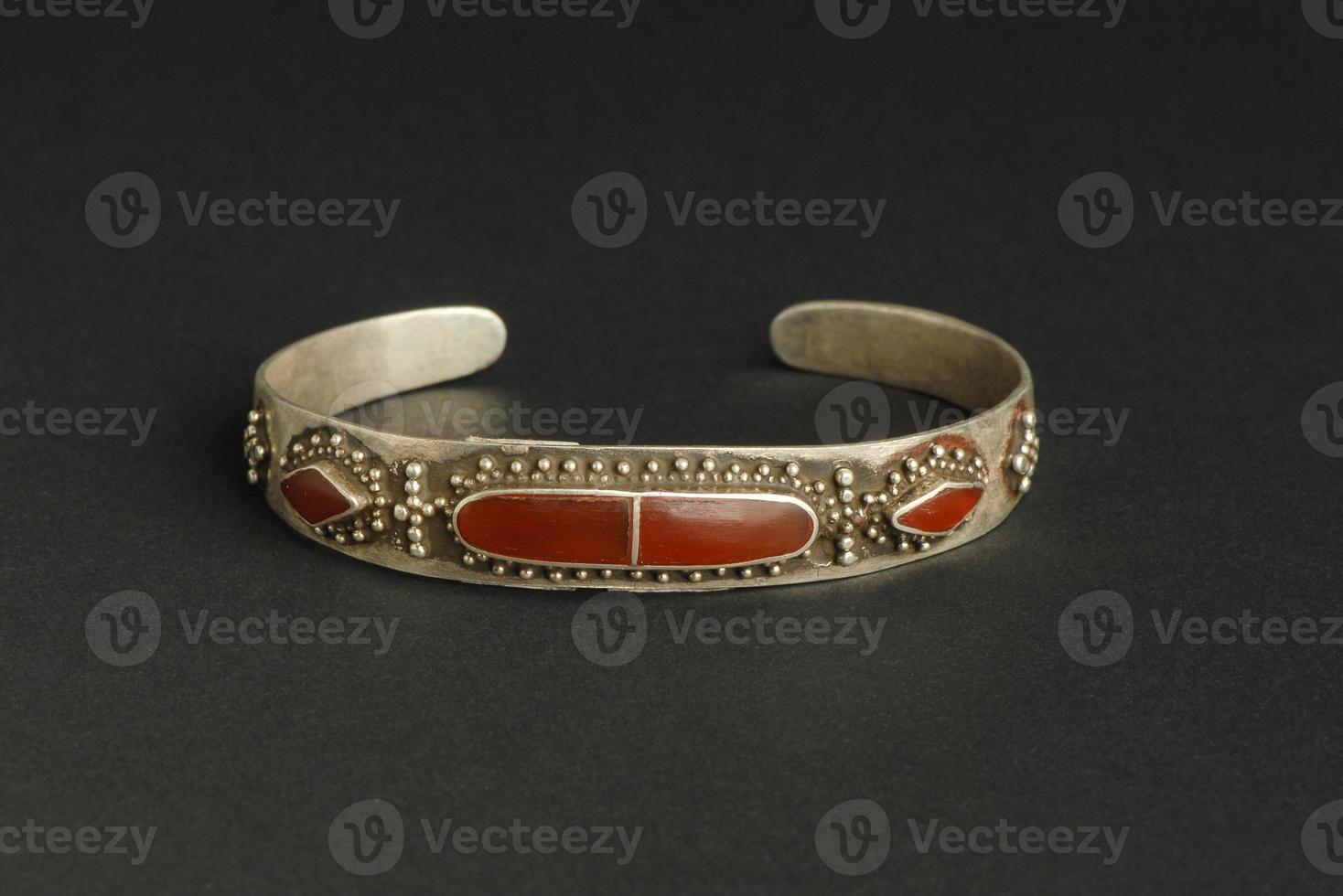 ancient antique bracelet with stones on black background. Middle Asian vintage jewelry photo