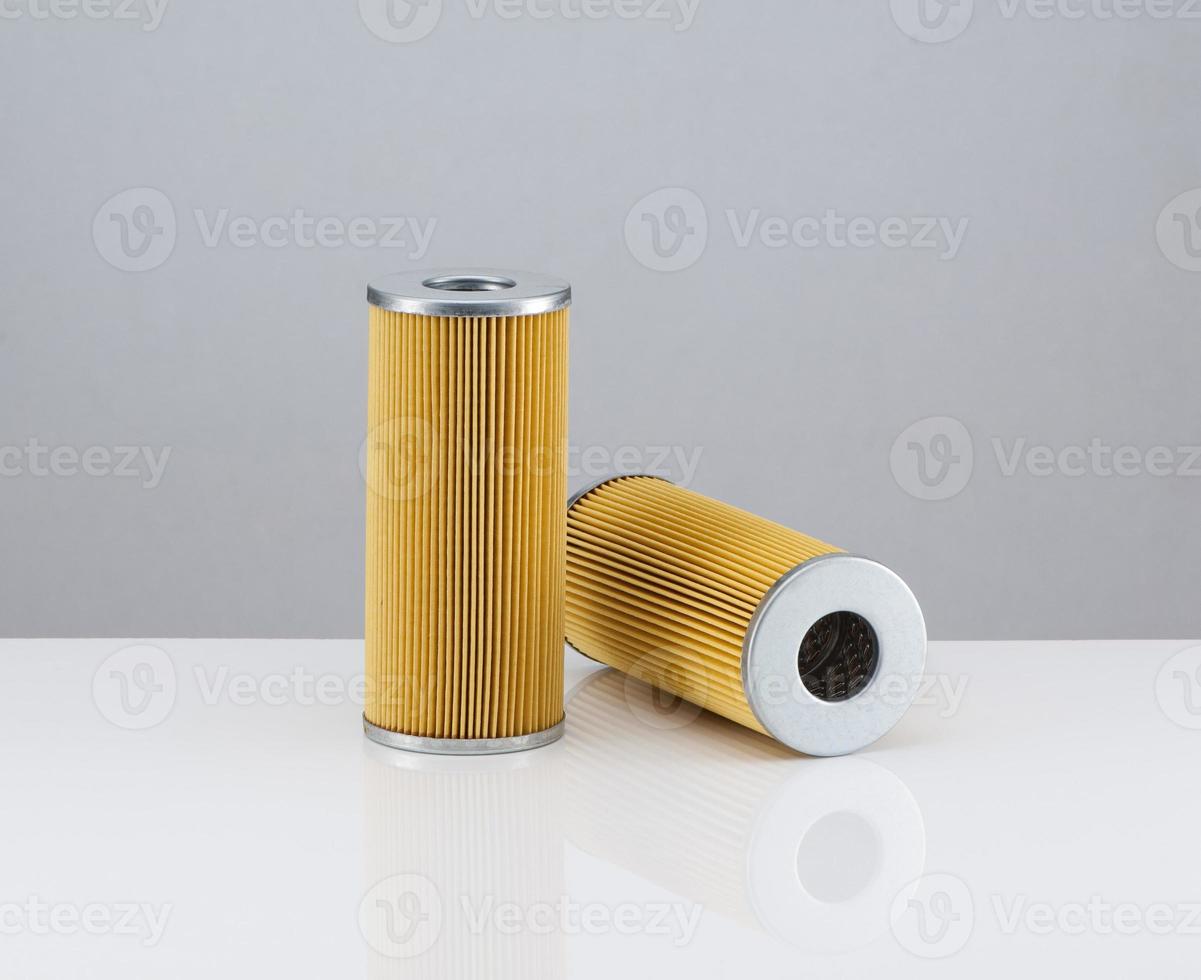 two automotive filter cylindrical shape  on a white background photo