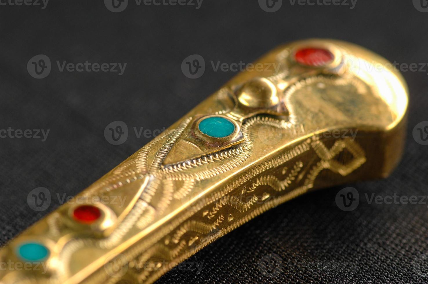 Decorative oriental knife decorated with precious gemstones photo