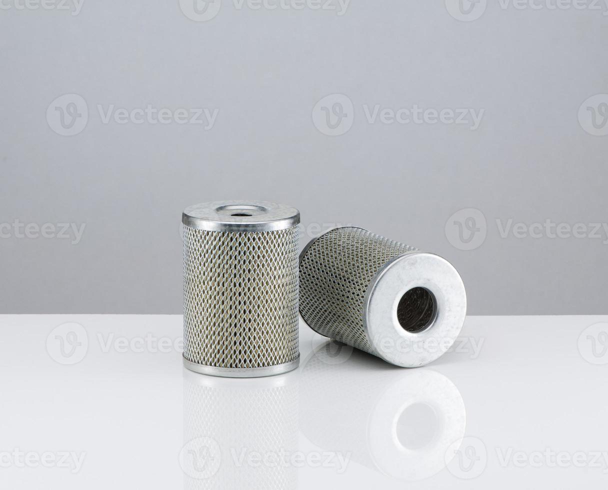 two automotive filter cylindrical shape  on a white background photo