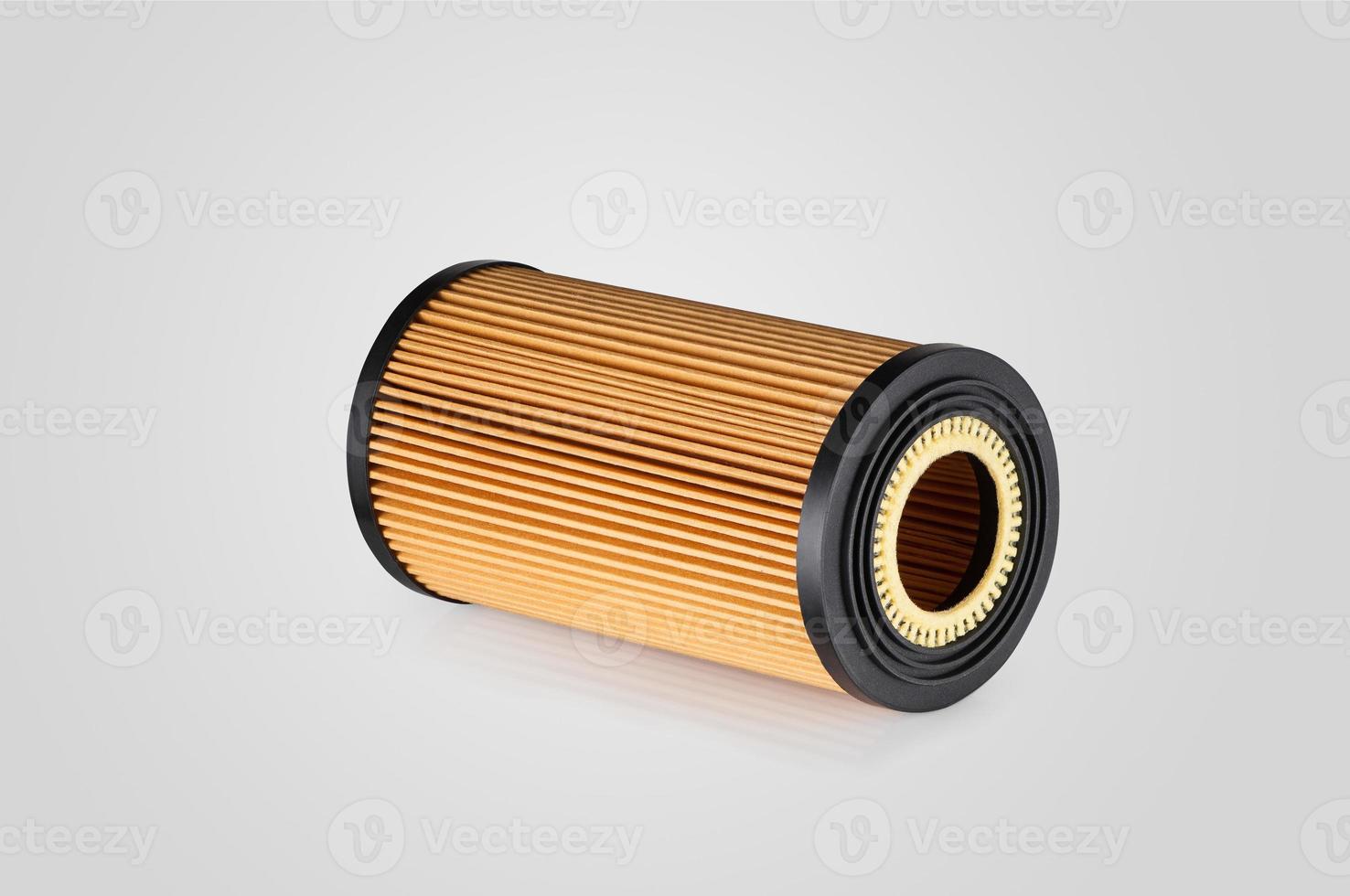 automotive filter cylindrical shape of orange color on a white background photo