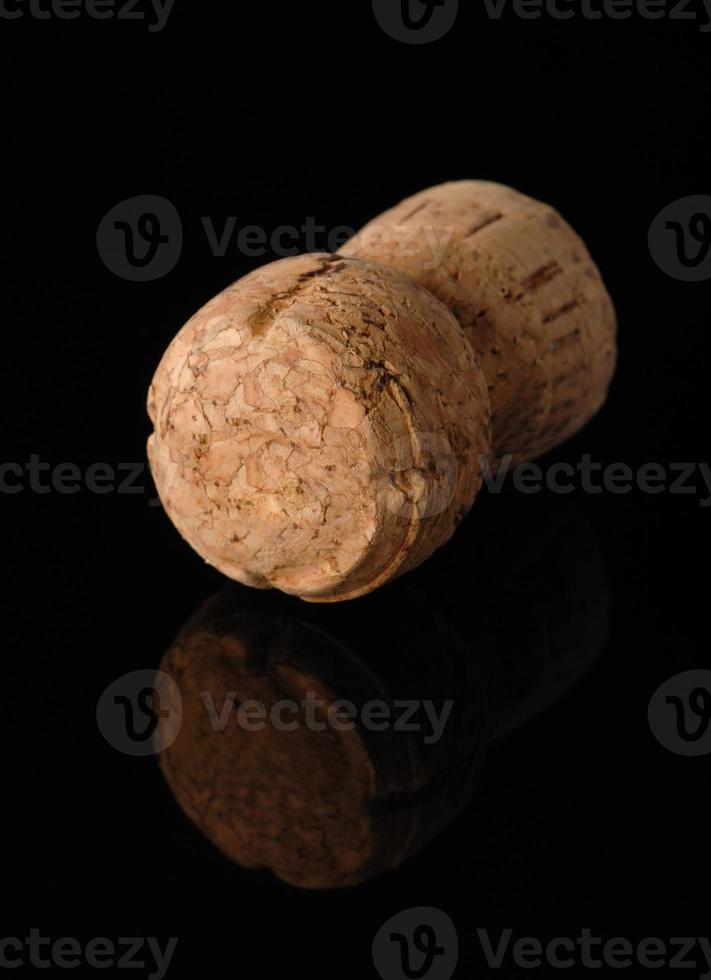 One old wine cork on black background with reflection photo