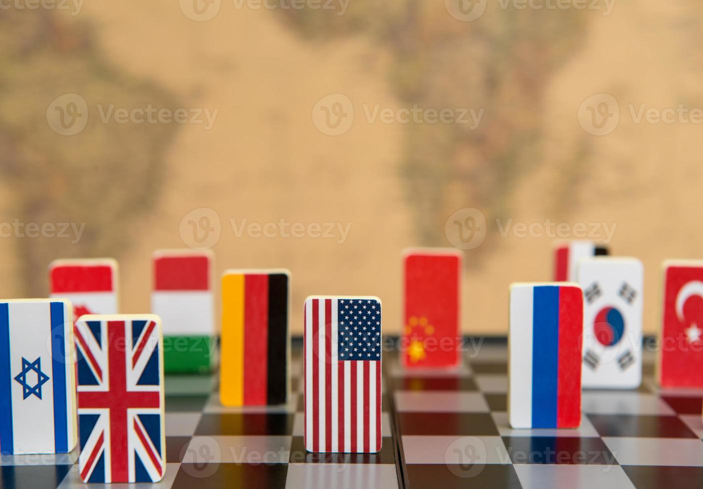 Symbols of countries on the chessboard against against the background the political map of the world. Political games. photo