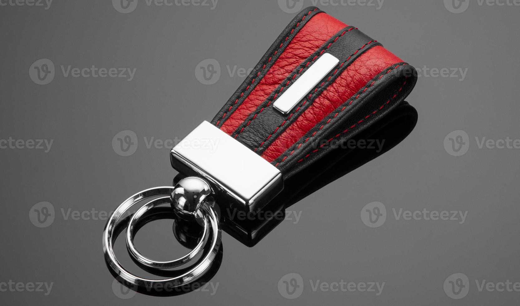 leather key chain with ring on black background photo