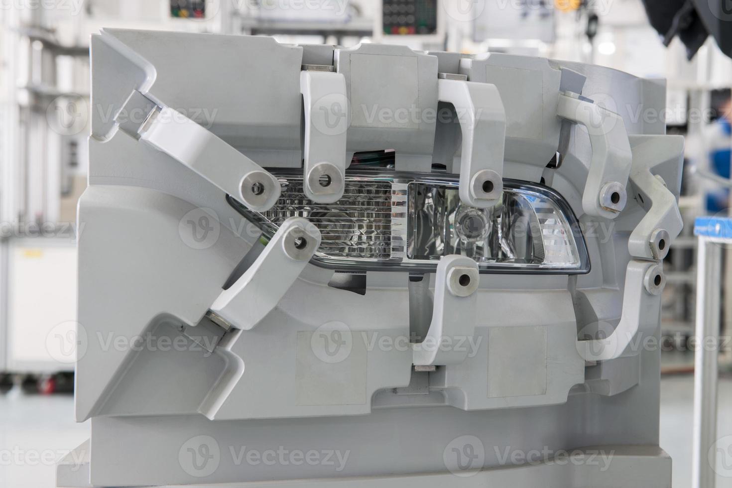 closeup factory equipment of quality control of car headlight. testing for compliance with the standard and size photo